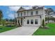 Two-story house with white brick exterior, landscaping, and a three-car garage at 4493 Eastbrook Pl, Snellville, GA 30039