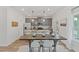 Modern kitchen with island, gray cabinets and dining area at 4493 Eastbrook Pl, Snellville, GA 30039