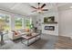 Bright living room with hardwood floors, fireplace, and access to backyard at 4493 Eastbrook Pl, Snellville, GA 30039