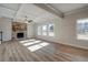 Living room features hardwood floors, a stone fireplace and coffered ceiling at 4493 Eastbrook Pl, Snellville, GA 30039