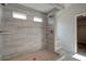 Large walk-in shower with gray tile and built-in seating at 4493 Eastbrook Pl, Snellville, GA 30039