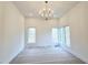 Bright bedroom with large windows and a statement chandelier at 165 Cedarwood Ln, Roswell, GA 30075