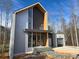 Modern two-story home with metal siding and attached garage at 165 Cedarwood Ln, Roswell, GA 30075