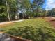 Newly sodded front yard with landscaping and a home in the background at 165 Cedarwood Ln, Roswell, GA 30075