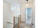 Upstairs hallway with simple wood railing and modern lighting at 165 Cedarwood Ln, Roswell, GA 30075