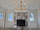 Living room with marble fireplace and modern chandelier at 165 Cedarwood Ln, Roswell, GA 30075