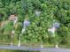 Aerial view of homes nestled within a wooded area at 1720 Mineral Springs Rd, Hoschton, GA 30548