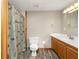 Basement bathroom with shower, toilet and wood vanity at 1720 Mineral Springs Rd, Hoschton, GA 30548