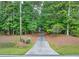 Long driveway leading to a house nestled in a wooded area at 1720 Mineral Springs Rd, Hoschton, GA 30548