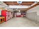 Unfinished garage with storage and exposed ceiling at 1720 Mineral Springs Rd, Hoschton, GA 30548