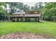 House exterior showcasing a deck, screened porch and wooded setting at 1720 Mineral Springs Rd, Hoschton, GA 30548