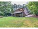 House exterior showcasing a deck, screened porch and wooded setting at 1720 Mineral Springs Rd, Hoschton, GA 30548