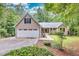 Tan house with two-car garage and landscaped yard at 1720 Mineral Springs Rd, Hoschton, GA 30548