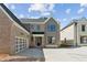 Beautiful new construction home featuring a brick and siding facade with an attached two-car garage at 102 Cottage Gate Ln, Roswell, GA 30076