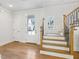 Bright foyer featuring hardwood floors, stairs with wood and iron railing, and a glass-paned door at 102 Cottage Gate Ln, Roswell, GA 30076