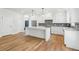 Charming kitchen with stainless steel appliances, large island and wood flooring at 102 Cottage Gate Ln, Roswell, GA 30076