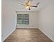 A bright bedroom features a ceiling fan and two windows that let in natural light at 1084 Village Main St, Stone Mountain, GA 30088