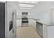 Kitchen with stainless steel appliances, white cabinetry, and light countertops at 1084 Village Main St, Stone Mountain, GA 30088