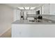 Updated kitchen featuring white cabinets, modern appliances, and neutral countertops at 1084 Village Main St, Stone Mountain, GA 30088