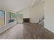 Bright living room with vaulted ceiling, brick fireplace, large windows, and hardwood floors at 1084 Village Main St, Stone Mountain, GA 30088