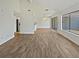 Spacious open-concept living room with hardwood floors and an adjacent kitchen at 1084 Village Main St, Stone Mountain, GA 30088