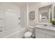 Clean bathroom with white bathtub, toilet, and marble-like vanity at 338 Elgin Dr, Lawrenceville, GA 30045