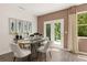 Bright dining room with stylish table, seating, decorative art and convenient access to the outdoors at 338 Elgin Dr, Lawrenceville, GA 30045