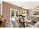 Elegant dining area with a table and chairs, a view to the backyard, and modern decor at 338 Elgin Dr, Lawrenceville, GA 30045
