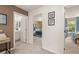Hallway featuring doorways to bedrooms and a bathroom, and warm colored walls with artwork at 338 Elgin Dr, Lawrenceville, GA 30045