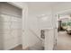 Hallway with walk in closet and view into the bedroom, stairs and artwork at 338 Elgin Dr, Lawrenceville, GA 30045