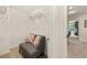 Walk-in closet with gray couch, overhead storage, and doorway view to a bed and window at 338 Elgin Dr, Lawrenceville, GA 30045