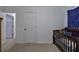 Bright bedroom with crib and access to hallway at 204 Wesley Mill Ln, Villa Rica, GA 30180