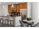 Modern kitchen with wood cabinets, stainless steel appliances, and granite counters at 1080 Peachtree Ne St # 1309, Atlanta, GA 30309