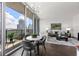 Open living space with dining area and stunning city views from balcony at 1080 Peachtree Ne St # 1309, Atlanta, GA 30309