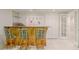 Basement bar area with seating for three, cabinetry, and adjacent doors at 1357 Baniff Ct, Snellville, GA 30078