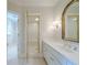 Bathroom with vanity featuring marble countertops and gold fixtures, adjacent walk-in shower at 1357 Baniff Ct, Snellville, GA 30078