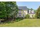 Traditional two-story home has a manicured lawn and mature landscaping at 1357 Baniff Ct, Snellville, GA 30078