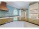 Kitchen featuring granite counters, blue walls, and a tile backsplash at 1357 Baniff Ct, Snellville, GA 30078