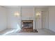 Elegant living room with a marble fireplace and wall sconces adds a touch of sophistication at 1357 Baniff Ct, Snellville, GA 30078