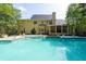 Inviting backyard pool with covered patio and well-manicured lawn is perfect for outdoor entertaining and summer fun at 1357 Baniff Ct, Snellville, GA 30078