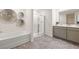 A modern bathroom has a soaking tub, a shower with glass doors and a double vanity at 308 Elgin Dr, Lawrenceville, GA 30045