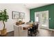 The dining room offers natural light from the glass door and a decorative green wall at 308 Elgin Dr, Lawrenceville, GA 30045