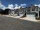 View of new two-story townhomes featuring modern architectural design and attached garages at 308 Elgin Dr, Lawrenceville, GA 30045