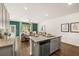 Open-concept kitchen features granite countertops, stainless appliances and island seating flowing into the living room with great light at 308 Elgin Dr, Lawrenceville, GA 30045