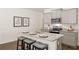Bright kitchen boasts granite countertops, island with seating, and stainless appliances, perfect for cooking and entertaining at 308 Elgin Dr, Lawrenceville, GA 30045