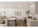 This kitchen offers granite countertops, stainless appliances, and an island with seating overlooking the dining area at 308 Elgin Dr, Lawrenceville, GA 30045