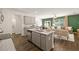 Open concept living and kitchen featuring hardwood floors, granite countertop and green accent wall at 308 Elgin Dr, Lawrenceville, GA 30045