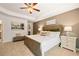 A large main bedroom features a decorative tray ceiling, a ceiling fan and en suite bathroom at 308 Elgin Dr, Lawrenceville, GA 30045