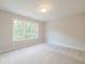 Bright bedroom with large window offering natural light and neutral carpeting at 1956 Deco Dr, Kennesaw, GA 30144