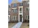 Charming brick townhome with a covered front entrance and manicured landscaping at 1956 Deco Dr, Kennesaw, GA 30144